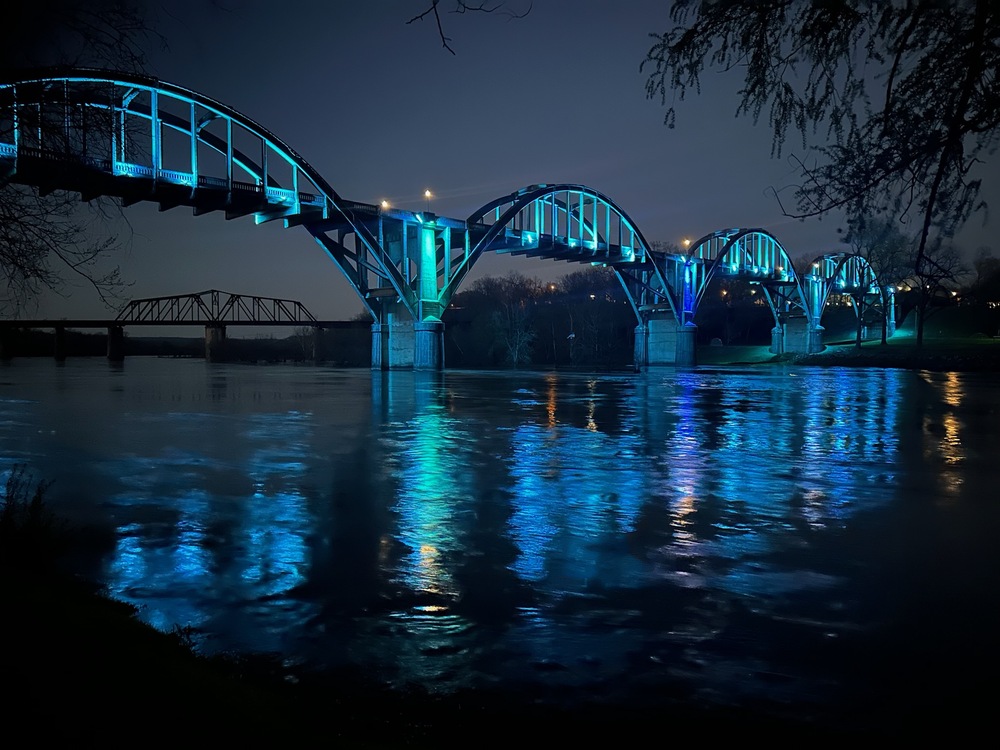 Cotter Bridge illuminated in blue and gold lights