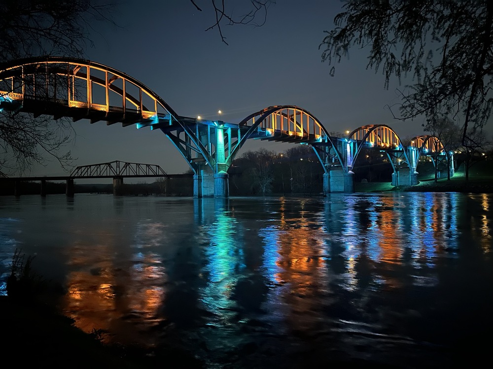 Bridge lit in gold and cyan colors