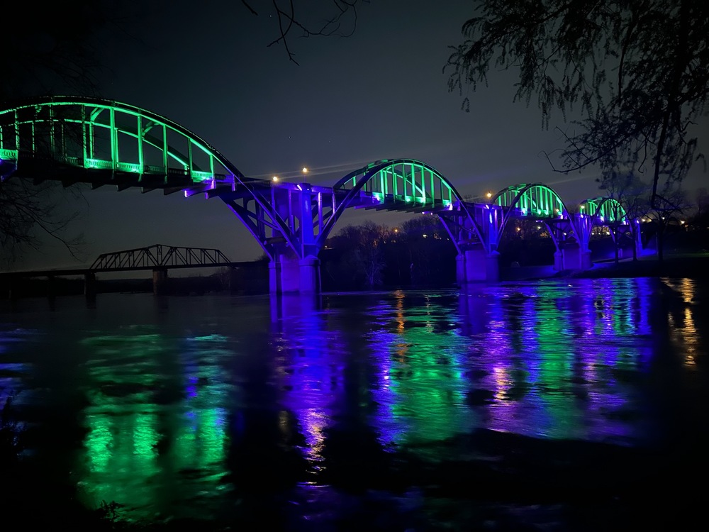 Bridge lit in bright green and blue lights