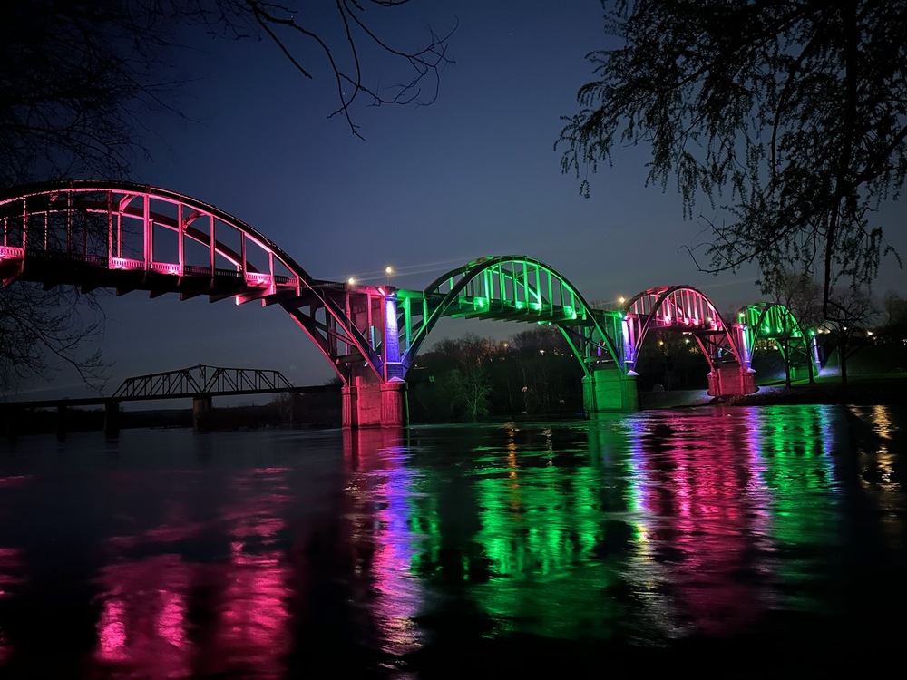 Bridge lit in pinks, greens, and blues