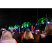 Attendees stand together, taking photos of the bridge as it lights up in different colors.